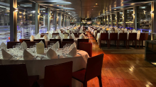 Elegantly set dining room for a Seine River dinner cruise